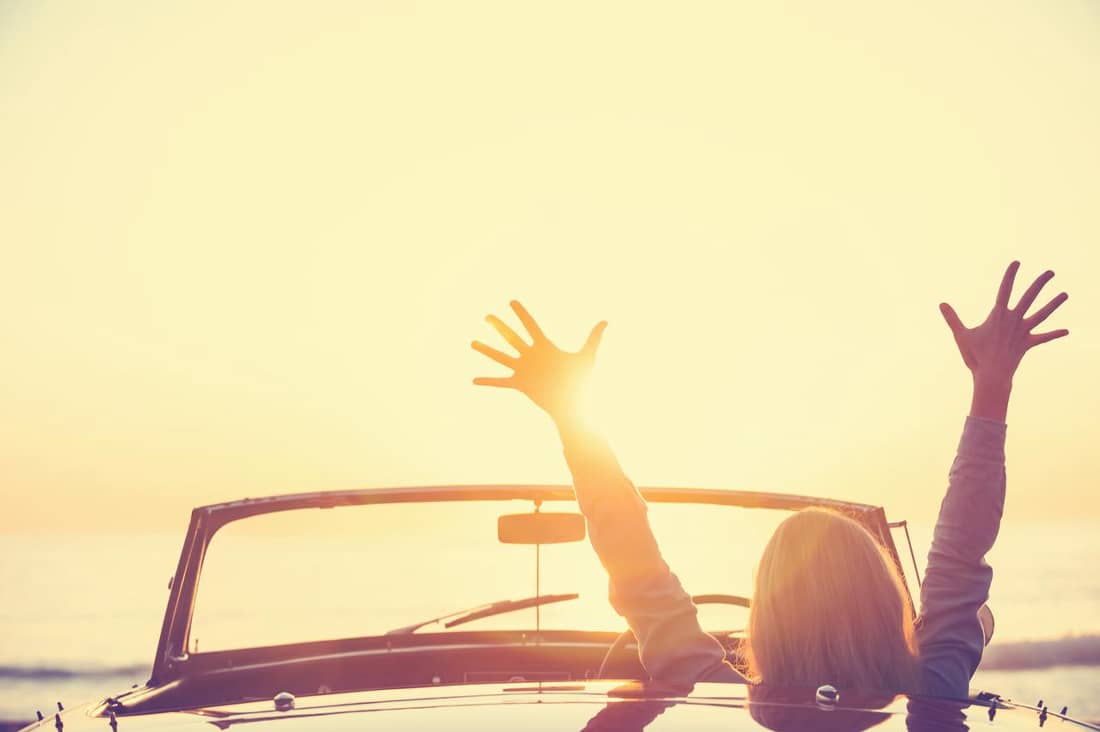 woman in car, cheering