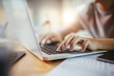 writing on laptop